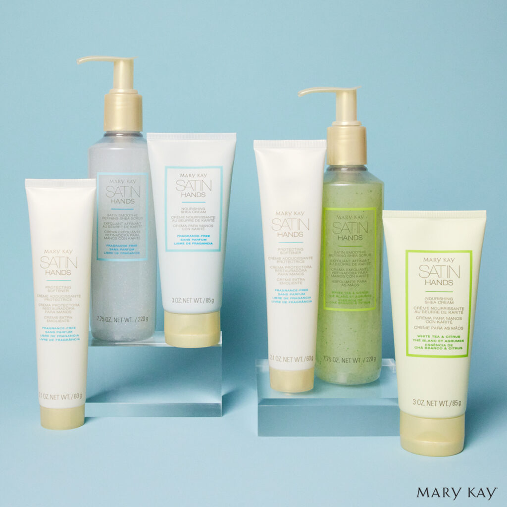 Mary Kay Satin Hands Pampering Set with shea scrub, hand cream, and softener in scented and fragrance-free on a clean blue background